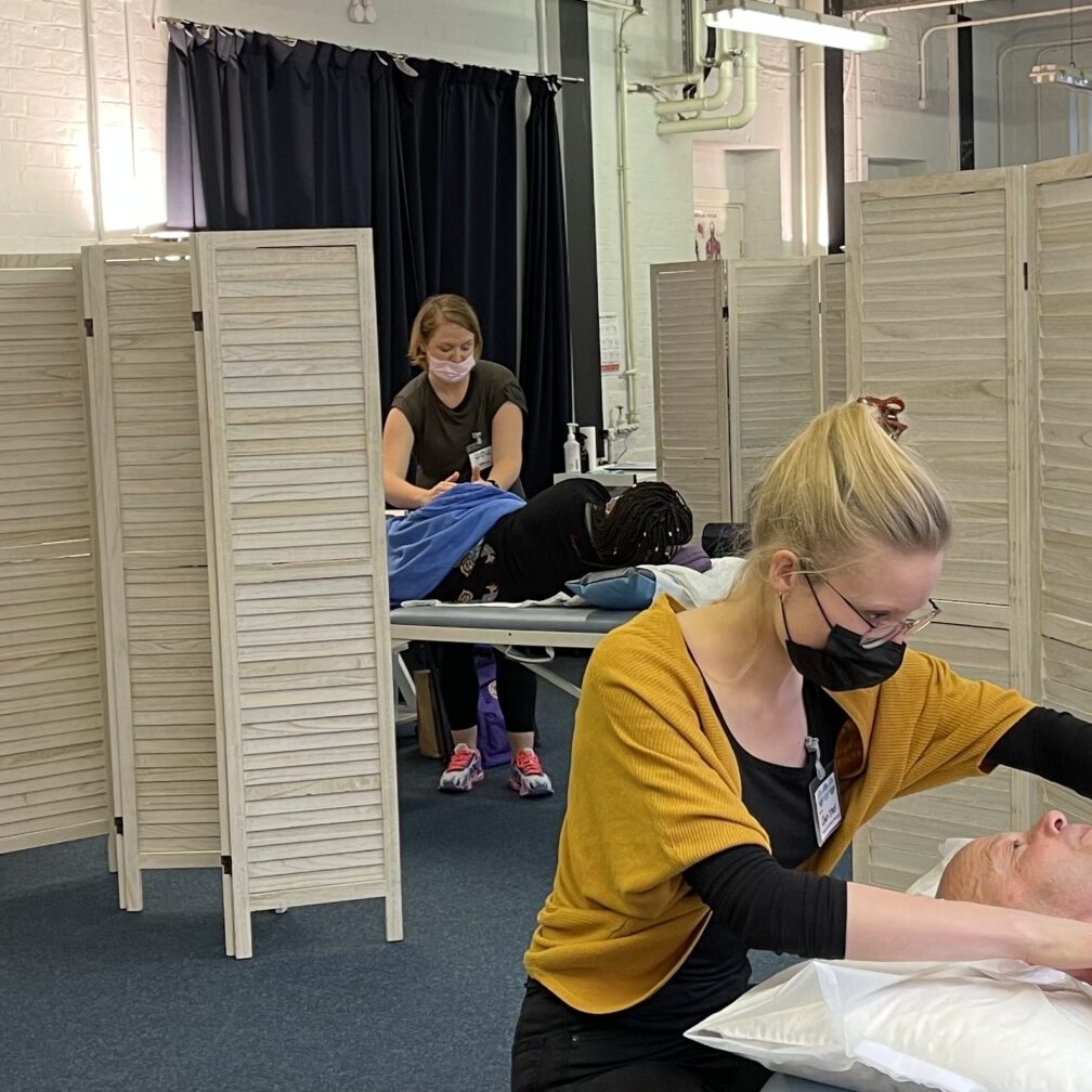 Volunteers receiving free scar therapy treatment behind screening